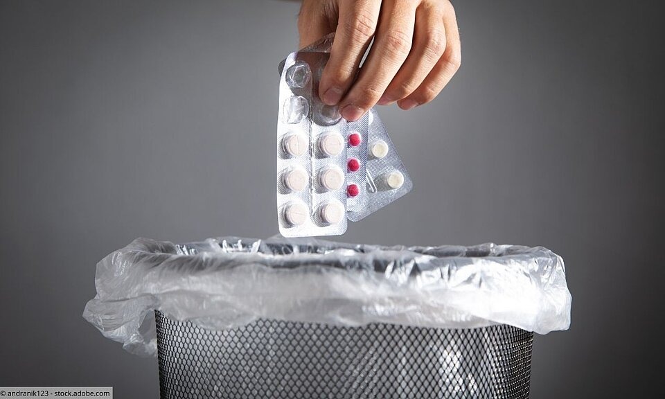 Entsorgung von Medikamenten Hand wirft Tabletten in Abfalleimer